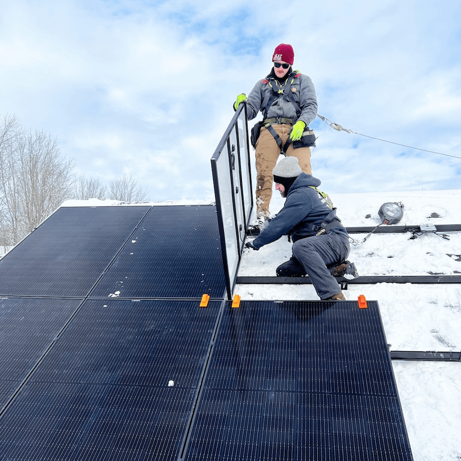 revision installers with solar panels in the winter