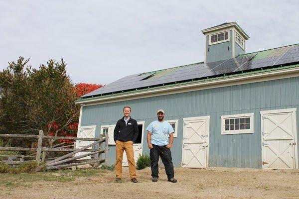 Chip And Gifford In Front Of Battery Ready Solar Home