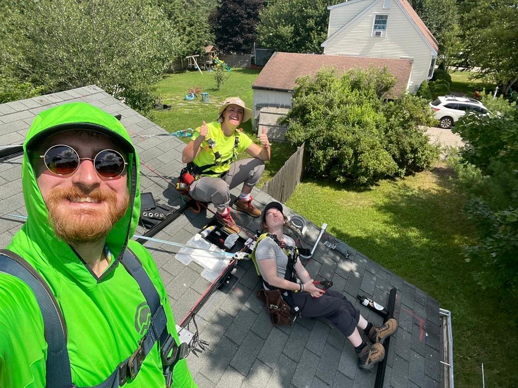 happy installers on roof summer.jpeg