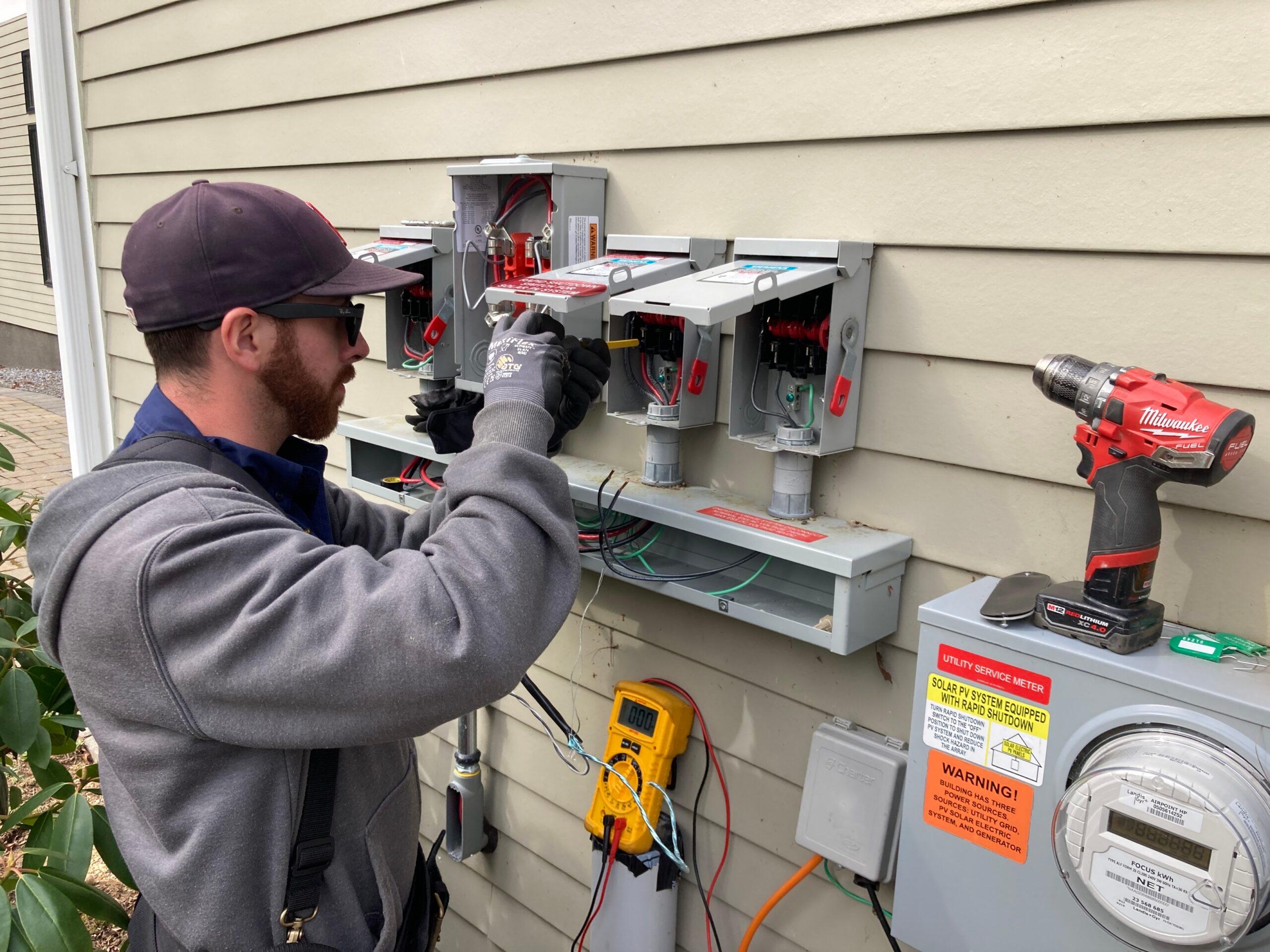 A ReVision technician servicing solar inverters 