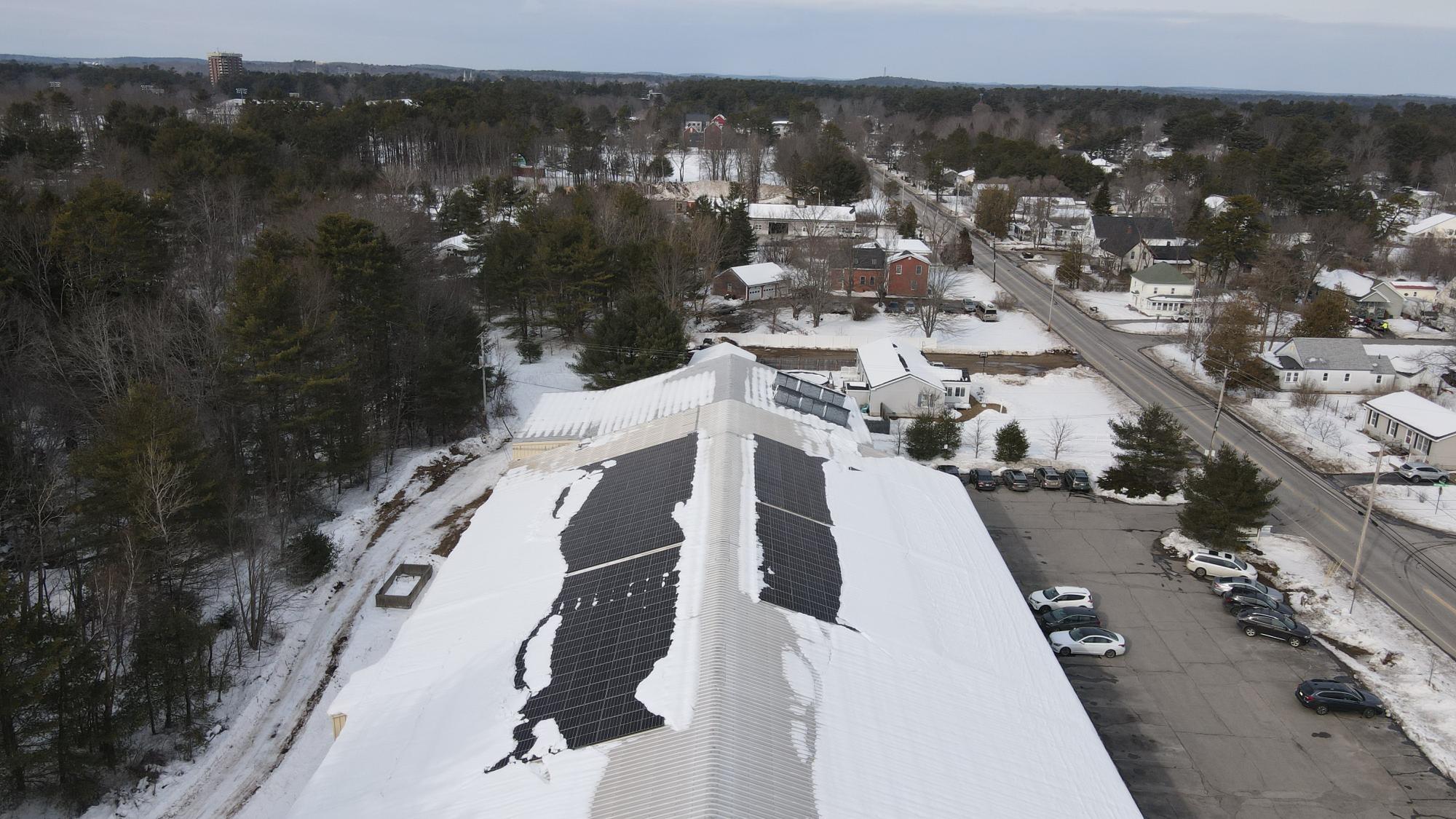 rooftop array shedding snow in winter.png