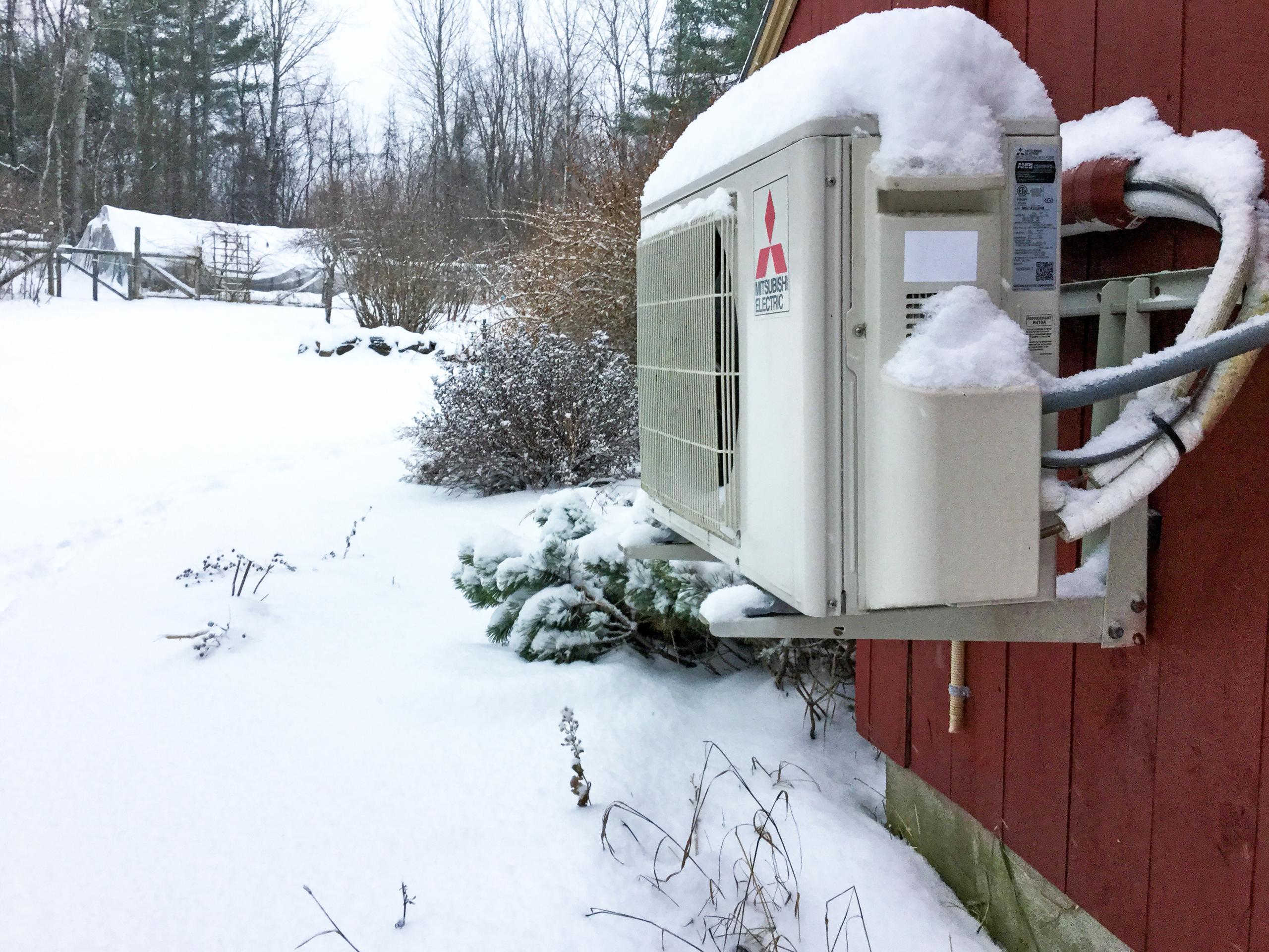Mitsubishi Air Source Heat Pump Outdoor Unit At Snowy Canterbury, NH Home
