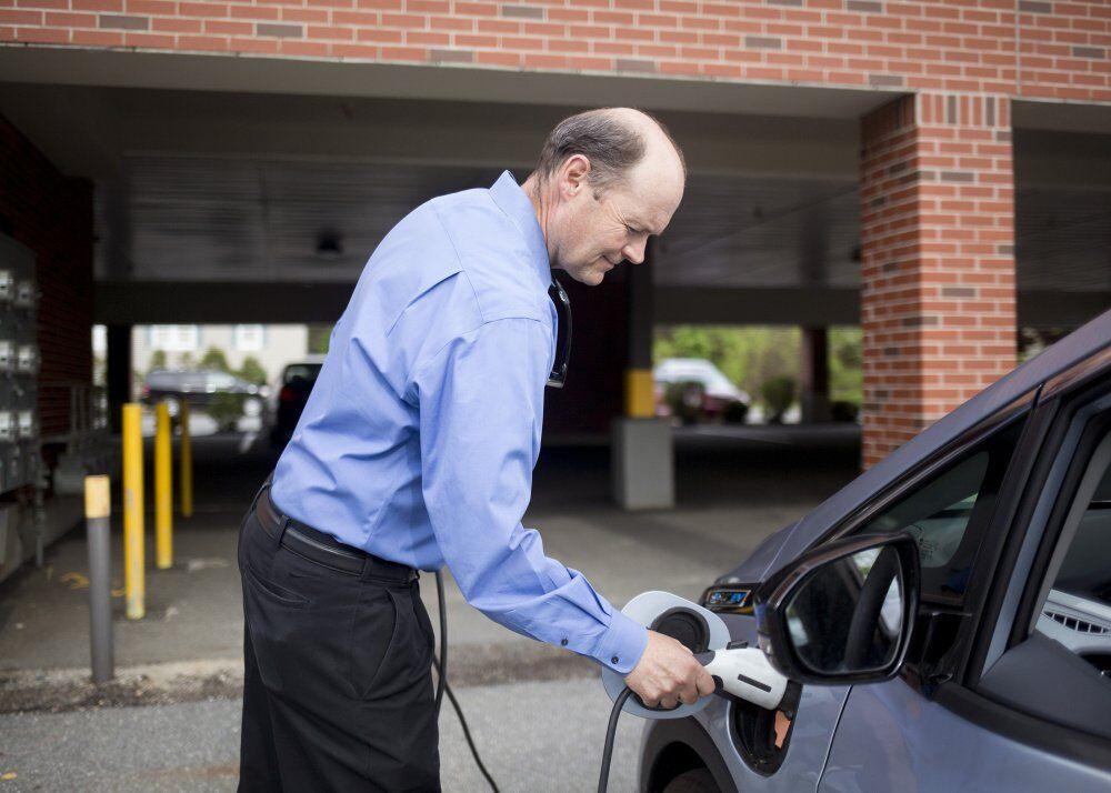 Barry Woods Plugs In An Electric Car In Portland, Maine. Photo Courtesy Portland Press Herald.